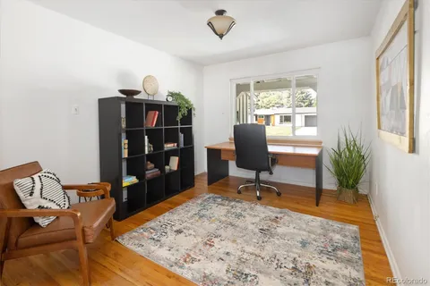 a view of a workspace with furniture and a window