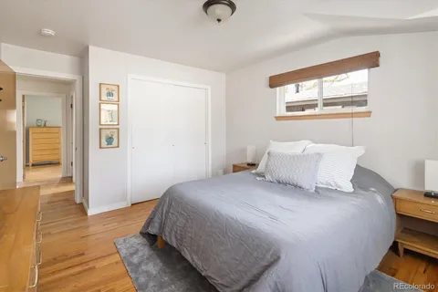a bedroom with a bed and wooden floor