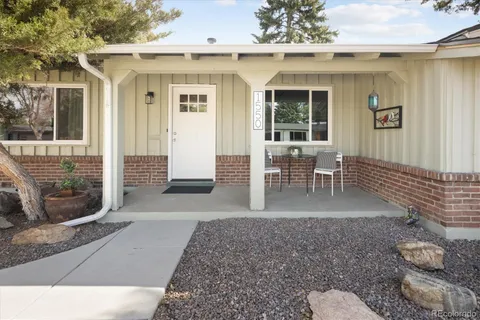 a view of a patio with table and chairs and wooden floor