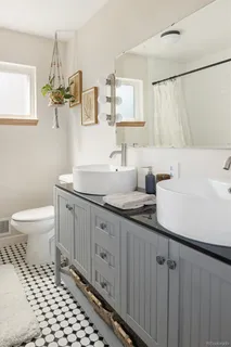 a bathroom with a sink a toilet and mirror