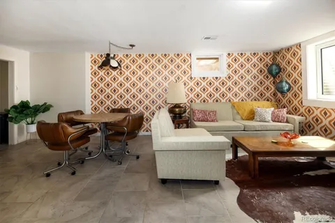 a living room with furniture and a potted plant