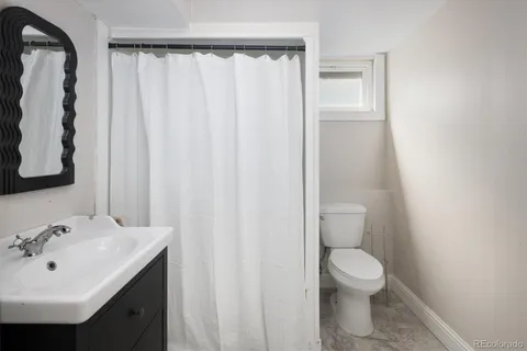 a bathroom with a sink a toilet and vanity