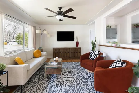 a living room with furniture fireplace and a large window