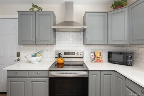 a kitchen with a sink a stove and cabinets