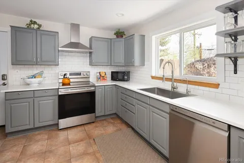 a kitchen with a sink stove and cabinets