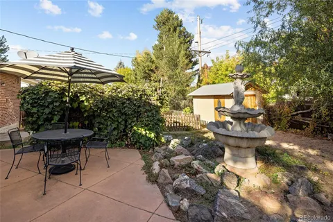 a view of a patio with table and chairs and potted plants