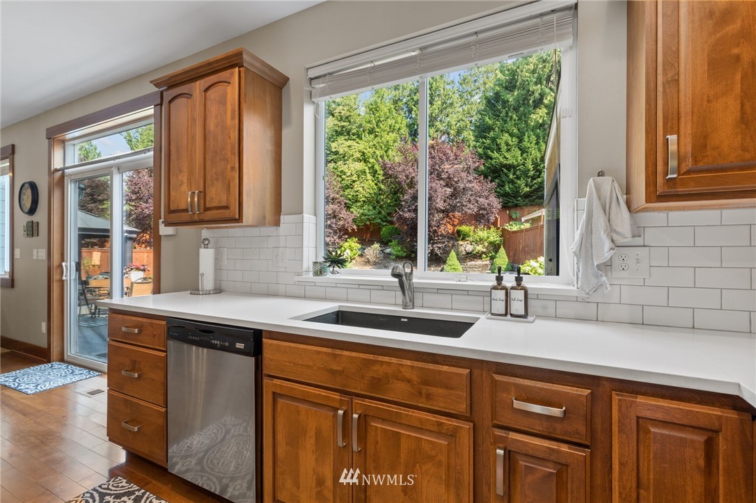 3113 223rd Street Southeast Bothell, WA 98021 - Photo 13 of 40 a kitchen with granite countertop a sink and a window