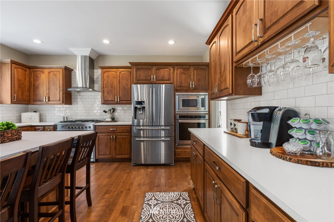 3113 223rd Street Southeast Bothell, WA 98021 - Photo 16 of 40 a kitchen with refrigerator and cabinets