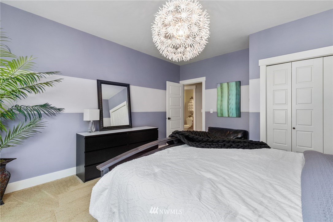3113 223rd Street Southeast Bothell, WA 98021 - Photo 18 of 40 a bedroom with a bed and a potted plant on the dresser