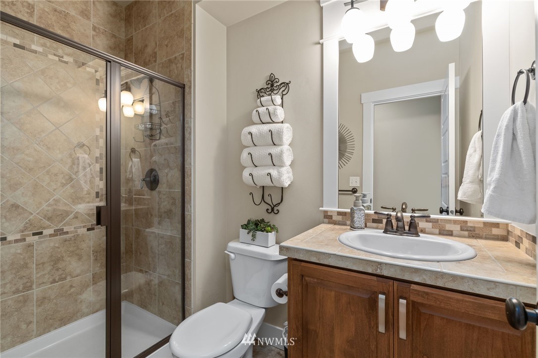 3113 223rd Street Southeast Bothell, WA 98021 - Photo 19 of 40 a bathroom with a sink a toilet and shower