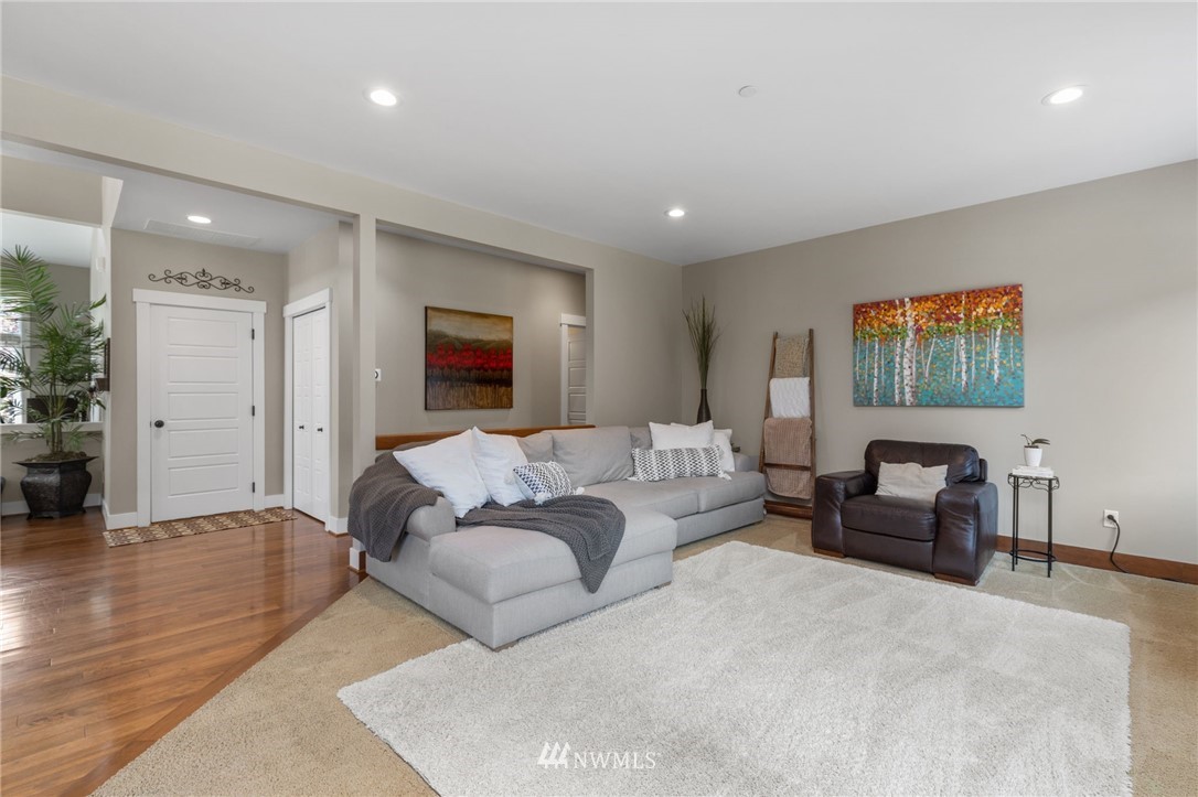 3113 223rd Street Southeast Bothell, WA 98021 - Photo 3 of 40 a living room with furniture and a flat screen tv
