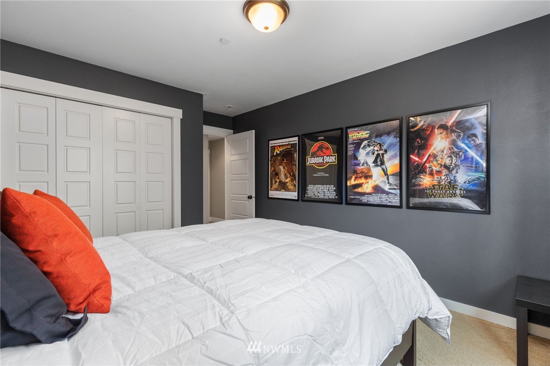 3113 223rd Street Southeast Bothell, WA 98021 - Photo 28 of 40 a bedroom with a bed and a painting on the wall