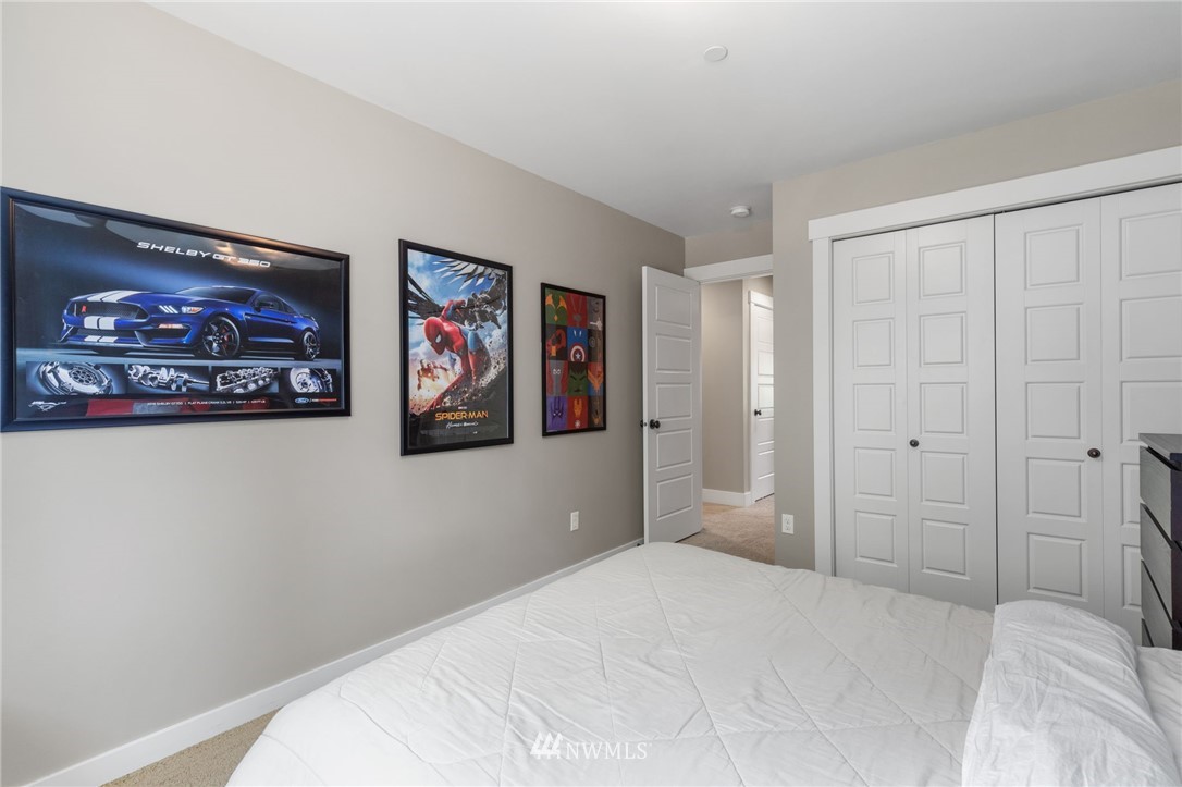 3113 223rd Street Southeast Bothell, WA 98021 - Photo 30 of 40 a bedroom with a large bed and a view of bathroom