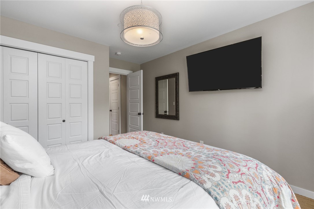 3113 223rd Street Southeast Bothell, WA 98021 - Photo 33 of 40 a bedroom with a bed and a flat screen tv