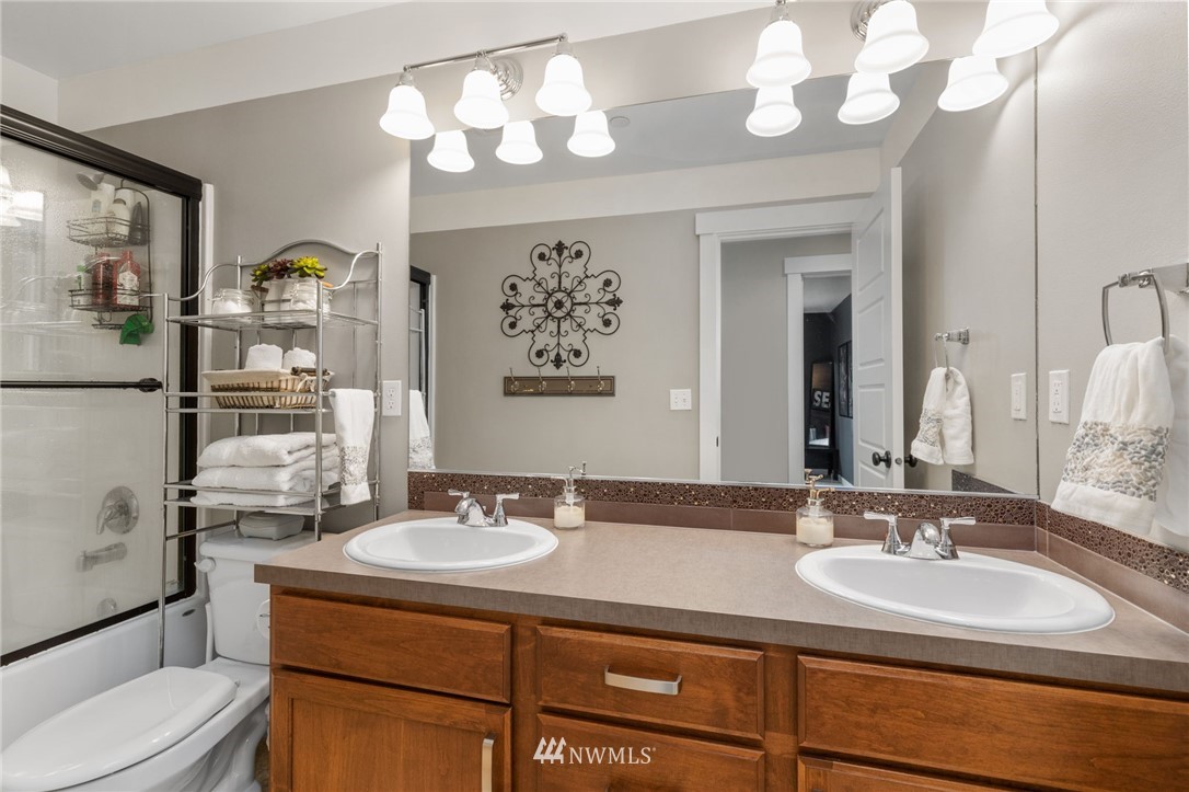 3113 223rd Street Southeast Bothell, WA 98021 - Photo 34 of 40 a bathroom with a sink a toilet and mirror