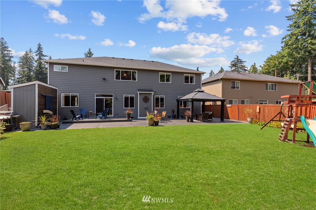 3113 223rd Street Southeast Bothell, WA 98021 - Photo 39 of 40 a view of a house with backyard porch and sitting area