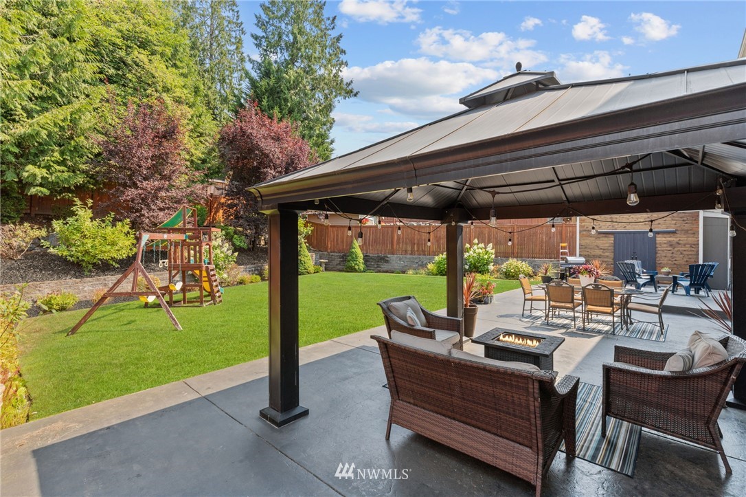 3113 223rd Street Southeast Bothell, WA 98021 - Photo 40 of 40 a view of a patio with a table chairs and a backyard