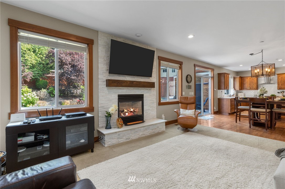 3113 223rd Street Southeast Bothell, WA 98021 - Photo 5 of 40 a living room with furniture and a fireplace