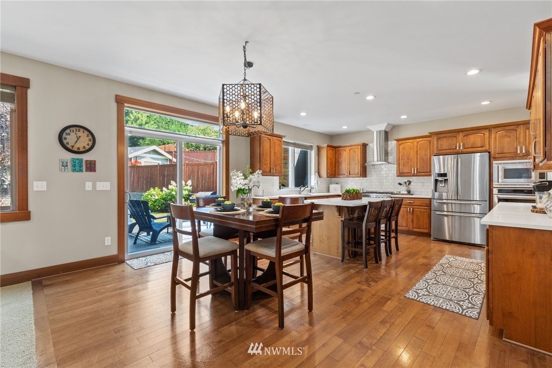 3113 223rd Street Southeast Bothell, WA 98021 - Photo 6 of 40 a view of a dining room with furniture window and wooden floor