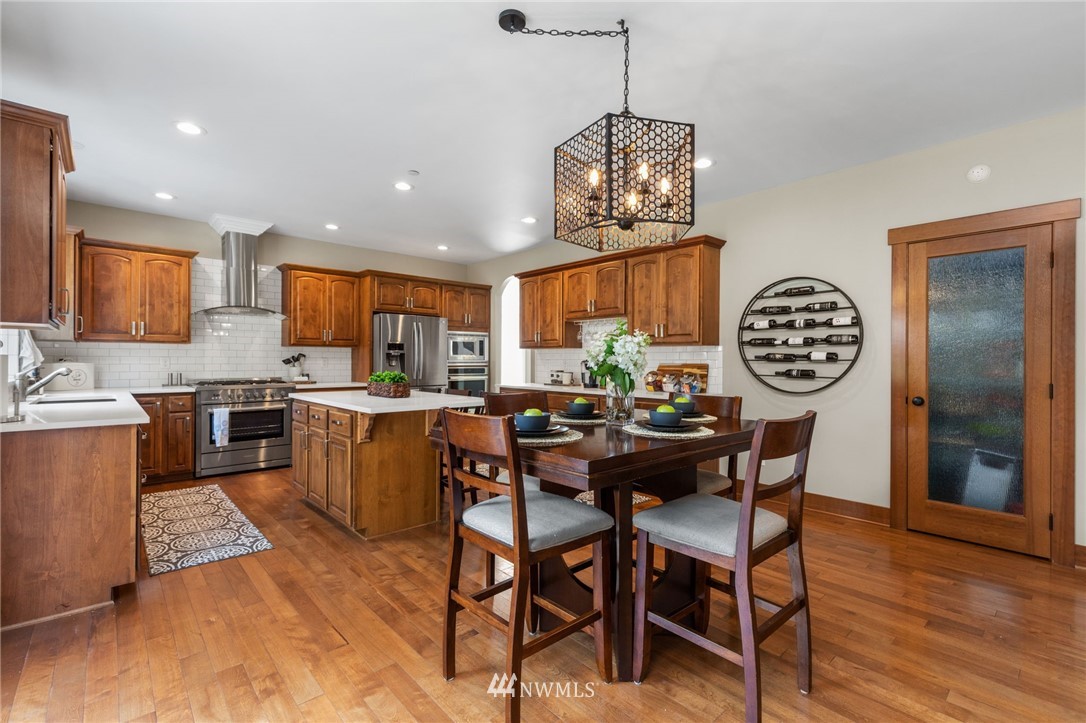 3113 223rd Street Southeast Bothell, WA 98021 - Photo 9 of 40 a view of a dining room with furniture window and wooden floor