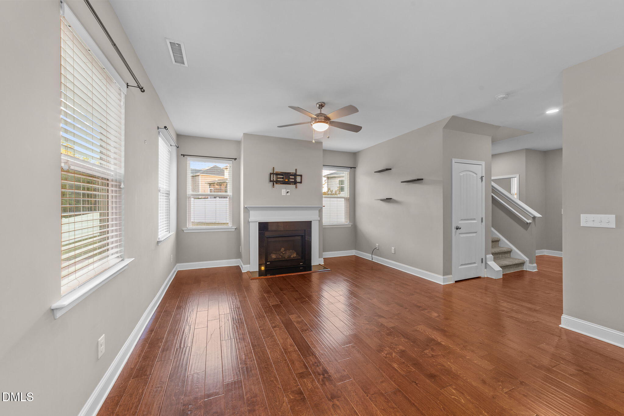 26 Mint Julip Circle Clayton, NC 27527 - Photo 10 of 46 an empty room with wooden floor fireplace and windows