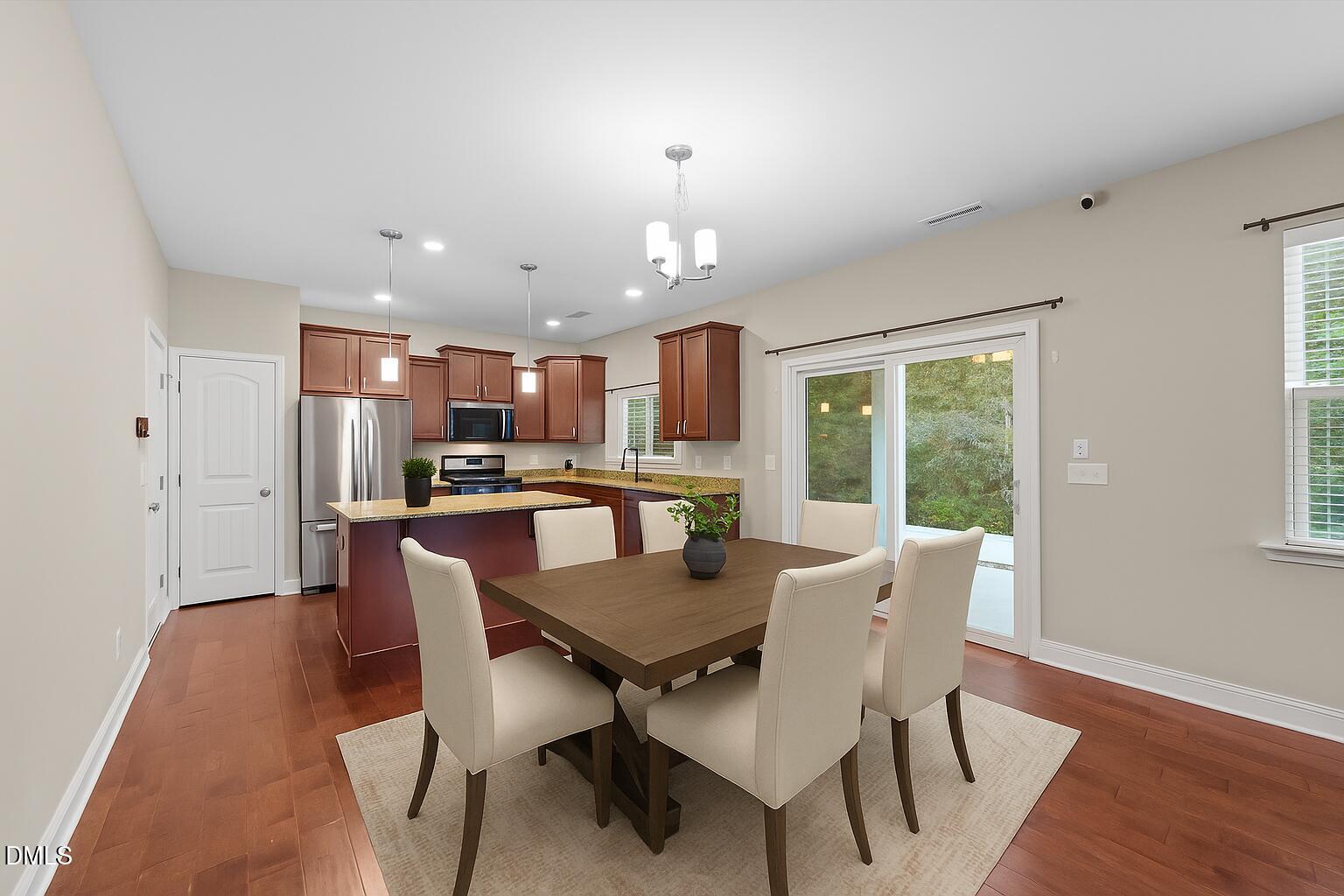26 Mint Julip Circle Clayton, NC 27527 - Photo 13 of 46 a view of a dining room with furniture window and wooden floor