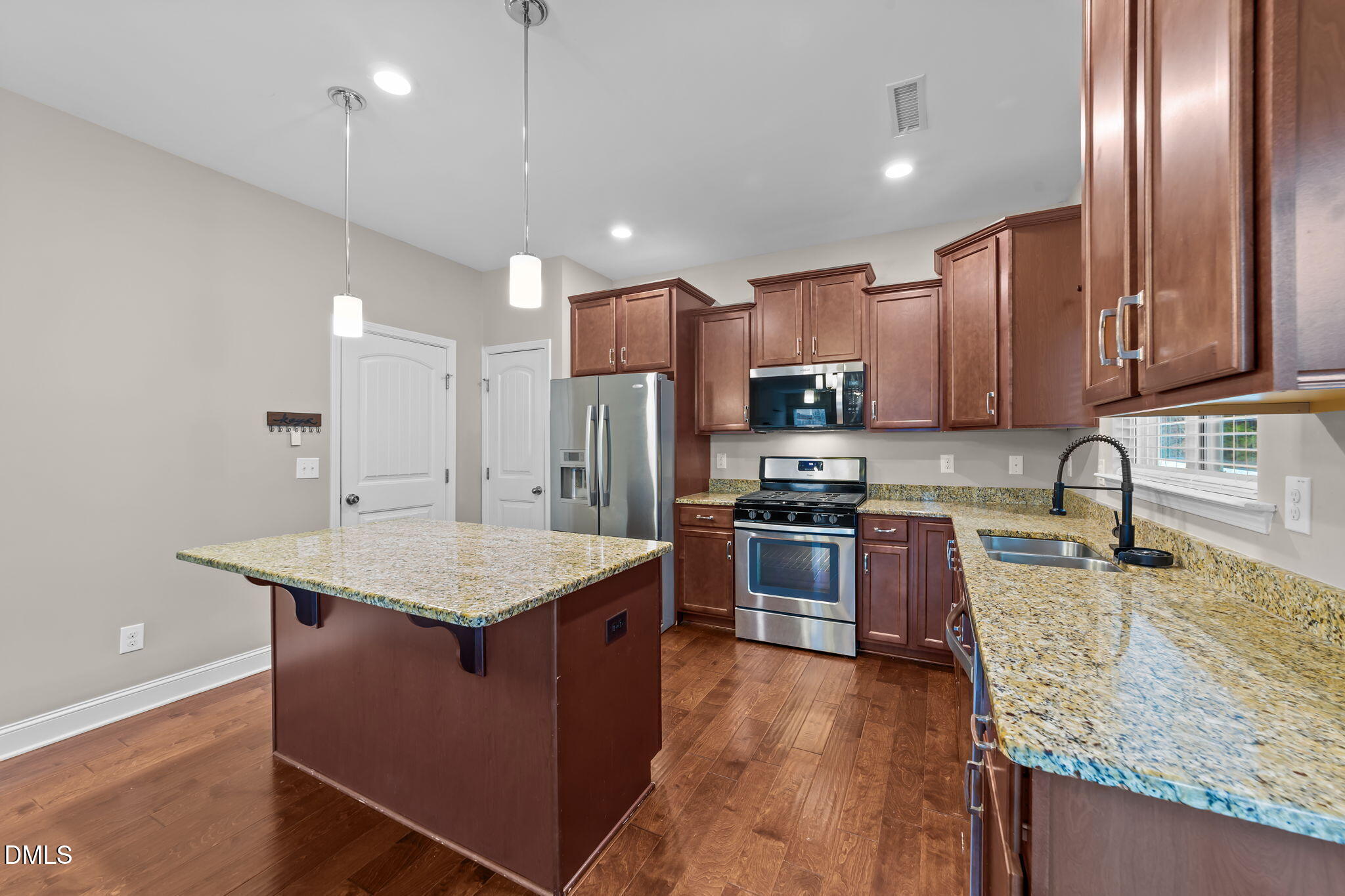 26 Mint Julip Circle Clayton, NC 27527 - Photo 14 of 46 a kitchen with stainless steel appliances granite countertop a sink stove and refrigerator