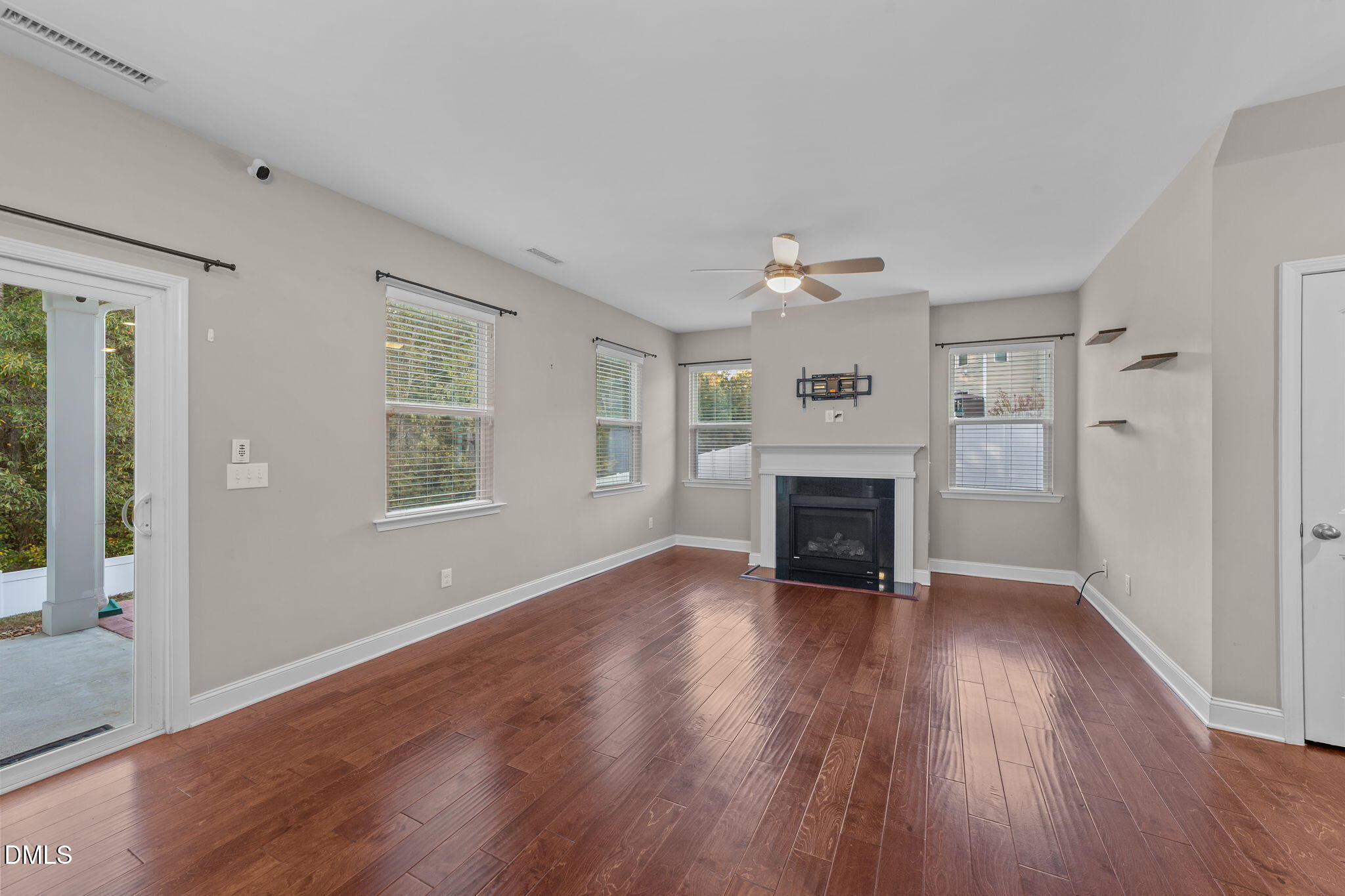 26 Mint Julip Circle Clayton, NC 27527 - Photo 7 of 46 an empty room with wooden floor fireplace and windows