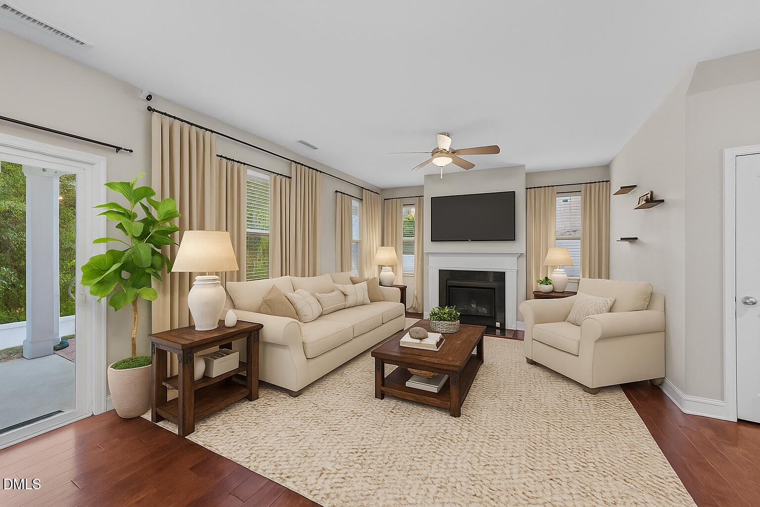 26 Mint Julip Circle Clayton, NC 27527 - Photo 8 of 46 a living room with furniture a fireplace and a potted plant