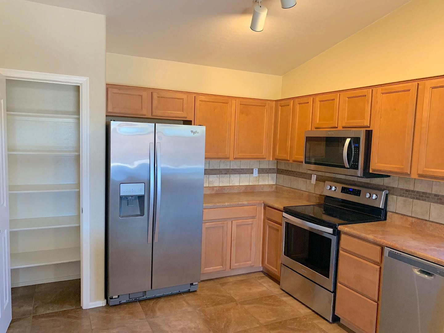 4132 East Chambers Street Phoenix, AZ 85040 - Photo 3 of 28 a kitchen with a refrigerator stove and microwave