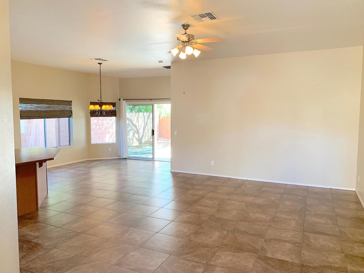 4132 East Chambers Street Phoenix, AZ 85040 - Photo 5 of 28 a view of an empty room with window and chandelier fan