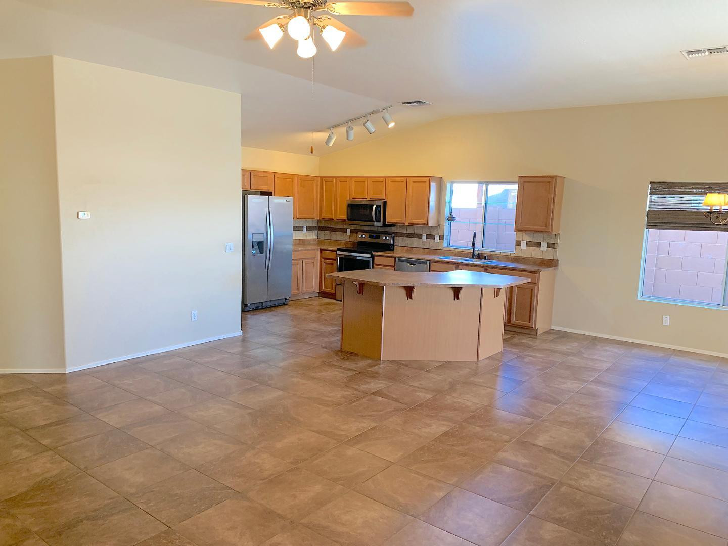 4132 East Chambers Street Phoenix, AZ 85040 - Photo 6 of 28 a kitchen with stainless steel appliances granite countertop a stove top oven a sink a counter space and cabinets