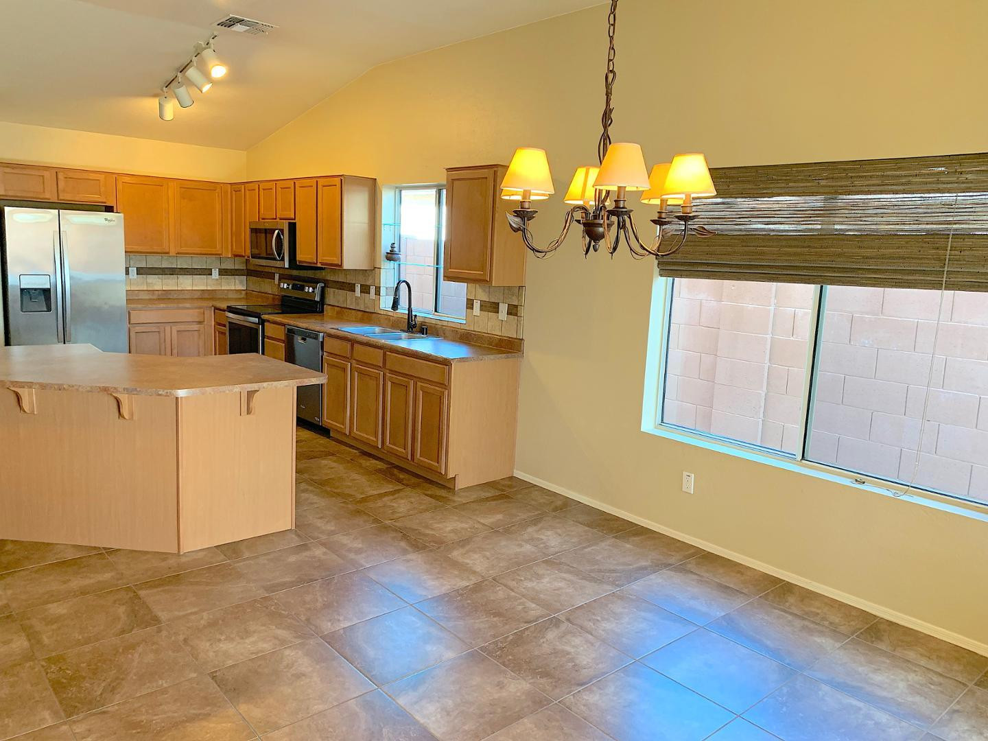4132 East Chambers Street Phoenix, AZ 85040 - Photo 8 of 28 a kitchen with stainless steel appliances granite countertop a stove a sink and a refrigerator