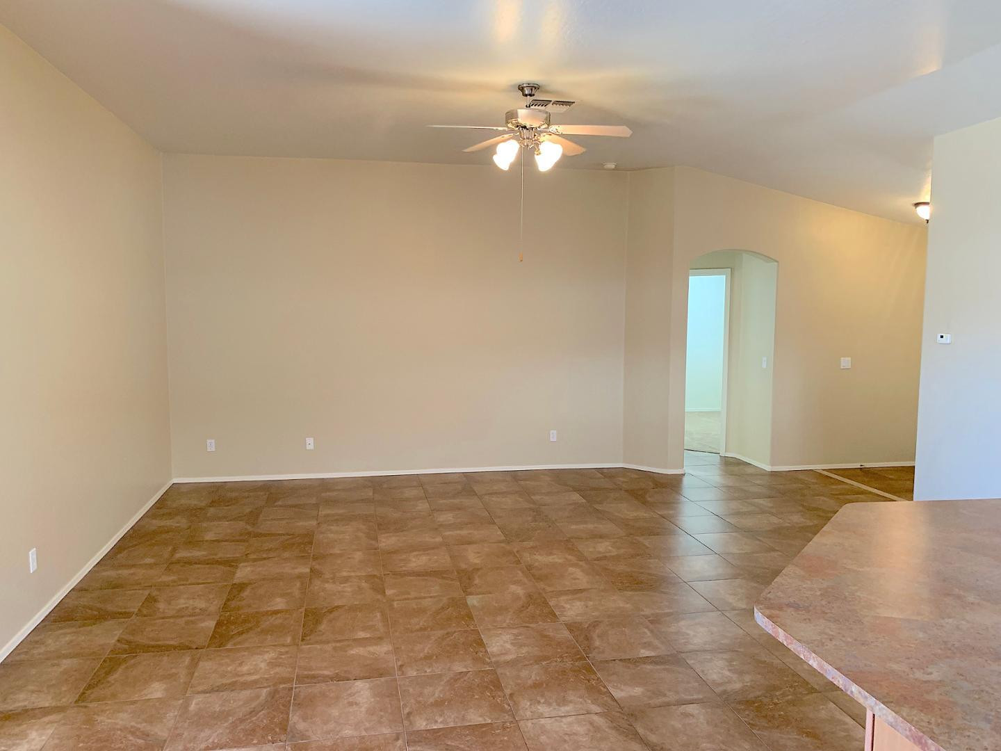 4132 East Chambers Street Phoenix, AZ 85040 - Photo 10 of 28 a view of an empty room with a chandelier fan