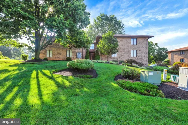 a view of backyard of house with green space