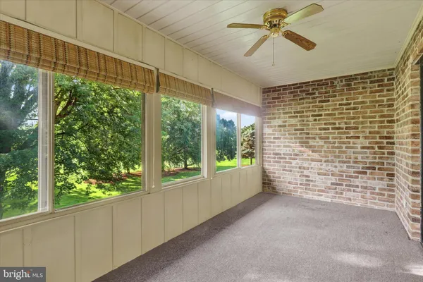 a view of a hallway with a ceiling fan