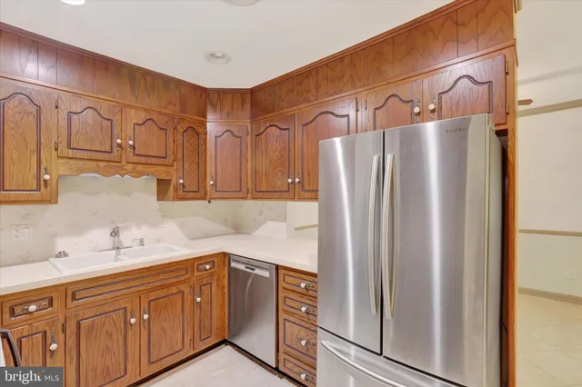 a kitchen with a refrigerator and cabinets