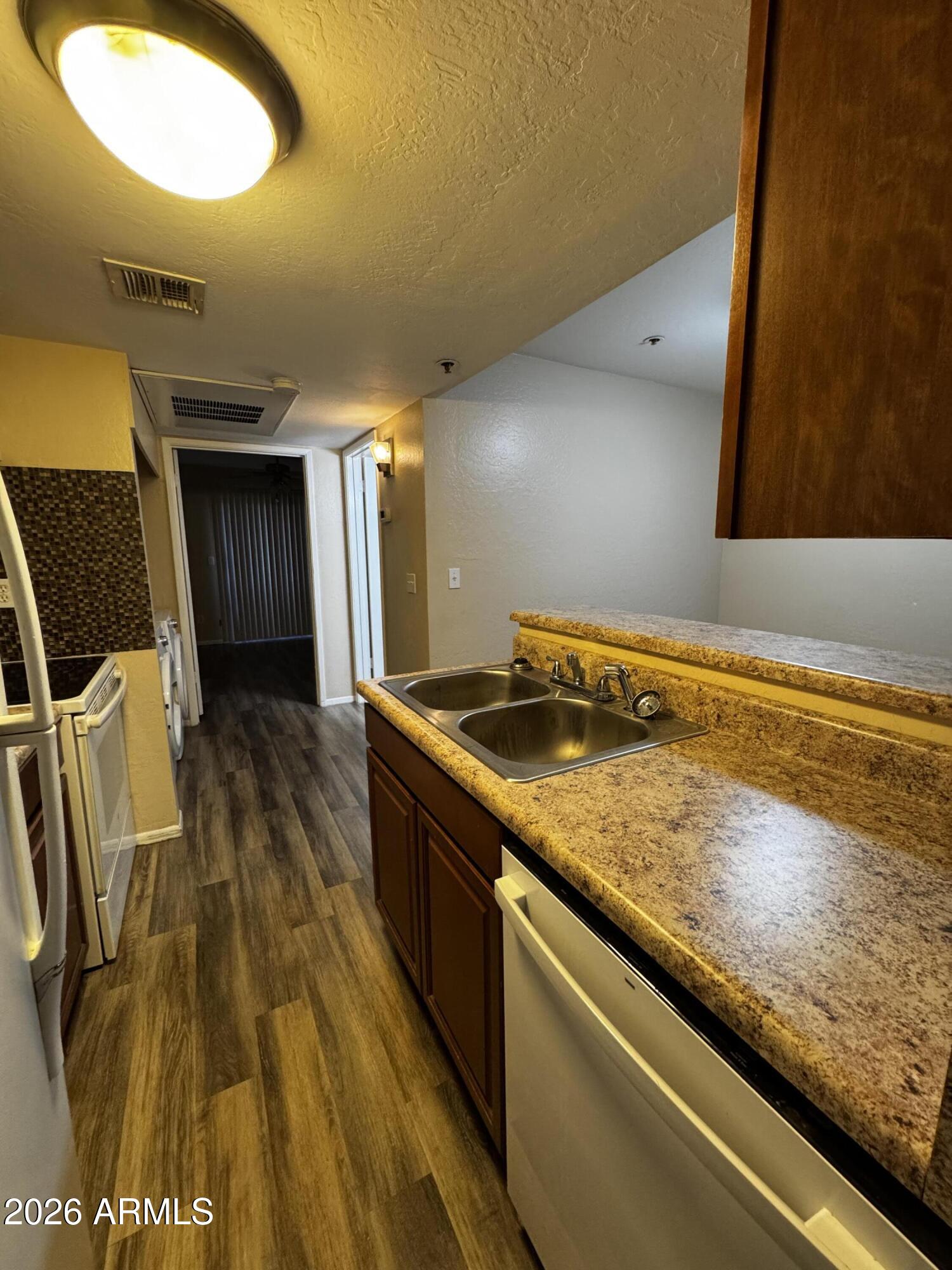 12123 West Bell Road, Unit 258 Surprise, AZ 85378 - Photo 5 of 30 a view of a kitchen with wooden floor