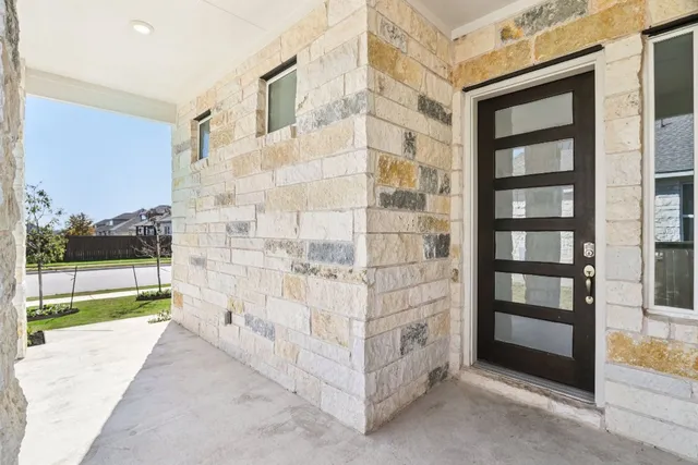 a view of a brick wall next to a yard