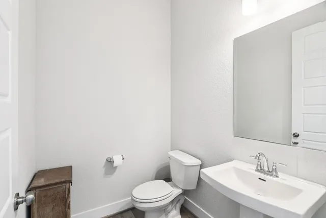 a view of a living room with wooden floor and a large window