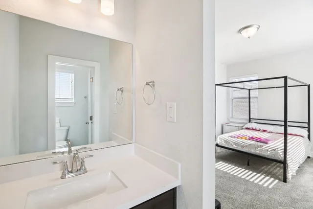a en suite bathroom with a sink and mirror