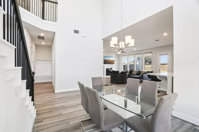 a view of a dining room with furniture and a chandelier