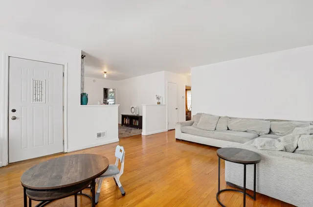 a living room with furniture and kitchen view