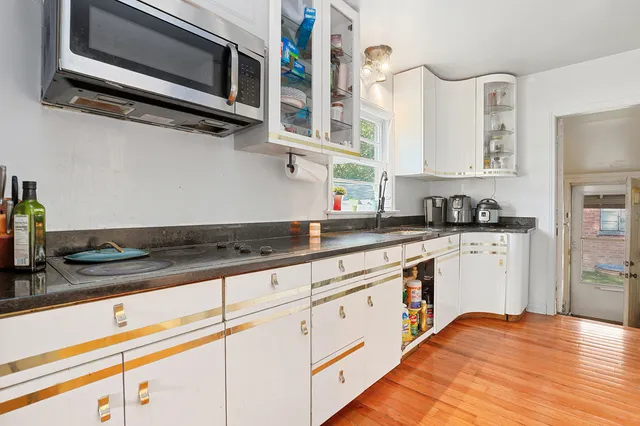 a kitchen with stainless steel appliances granite countertop a sink and a stove