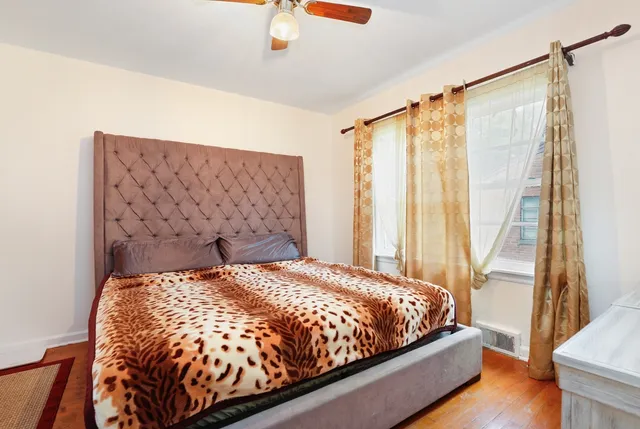 a bed sitting in a bedroom next to a window