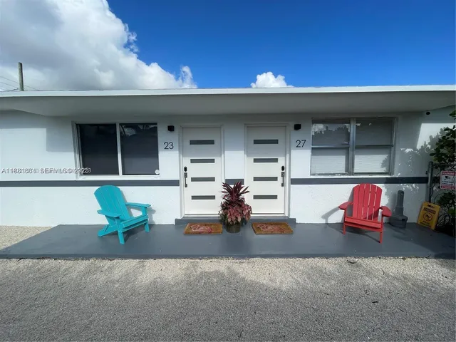 a view of a chairs and table in back of the house