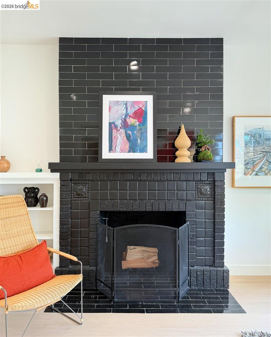 1668 Arch Street Berkeley, CA 94709 - Photo 9 of 78 Black tiled fireplace with a mantel, hearth, and white built-in shelving