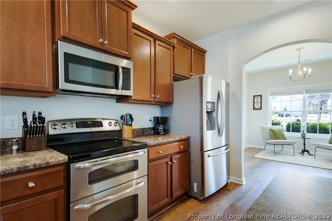 381 River Oaks St Spring Lake Spring Lake, NC 28390 - Photo 12 of 49 a kitchen with stainless steel appliances granite countertop a stove a refrigerator and a microwave
