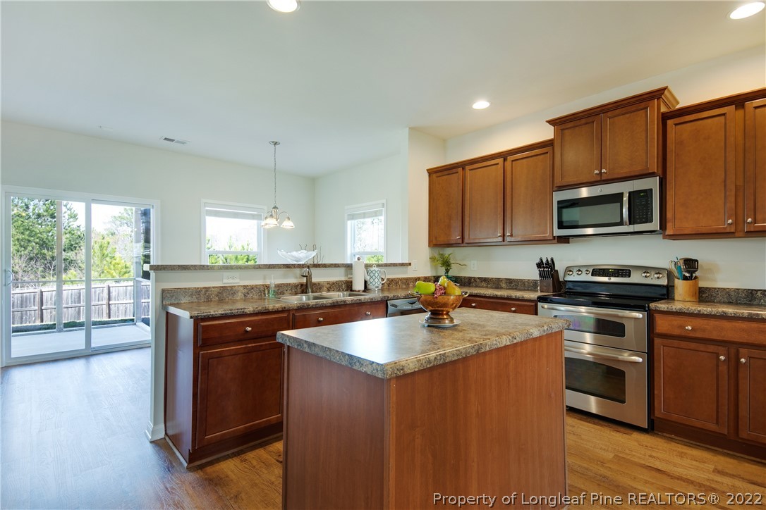 381 River Oaks St Spring Lake Spring Lake, NC 28390 - Photo 13 of 49 a kitchen with stainless steel appliances granite countertop a stove a sink and a microwave