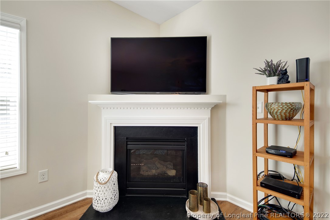 381 River Oaks St Spring Lake Spring Lake, NC 28390 - Photo 23 of 49 a living room with a fireplace and a flat screen tv